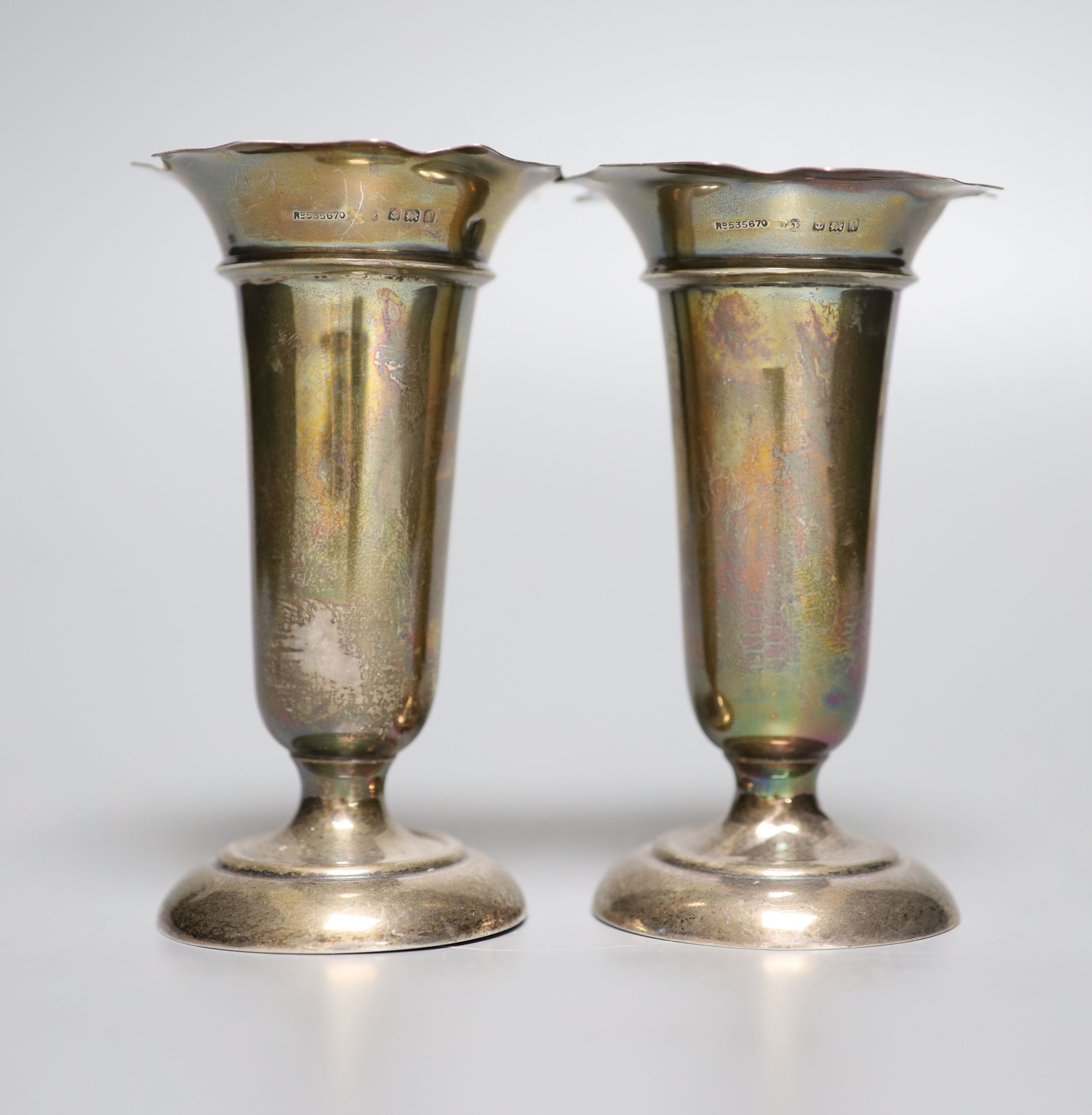 A pair of Edwardian silver vases, Birmingham, 1908, 11.1cm, weighted, four modern silver wine labels and a silver mounted cigarette box.